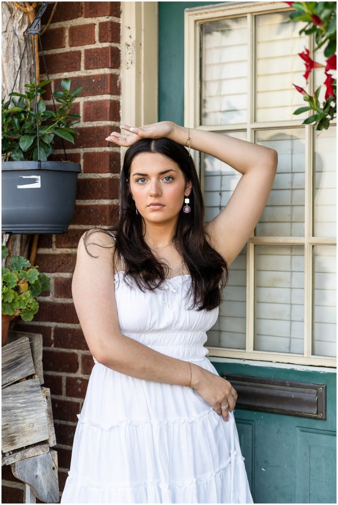 Senior girl poses by a flower shop in Columbia Missouri for her senior session with West Plains Photographer, Hannah Carr Photography.