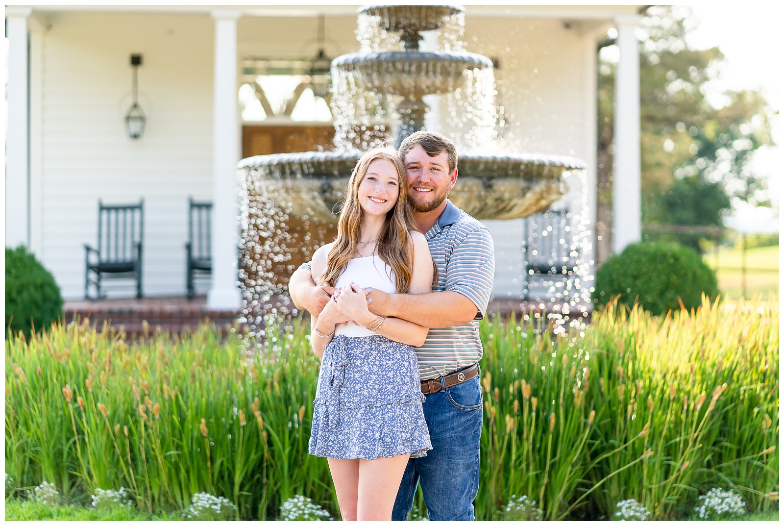 A newly engaged couple stands in front of a fountain at the Garden Chapel at Big Cedar Lodge