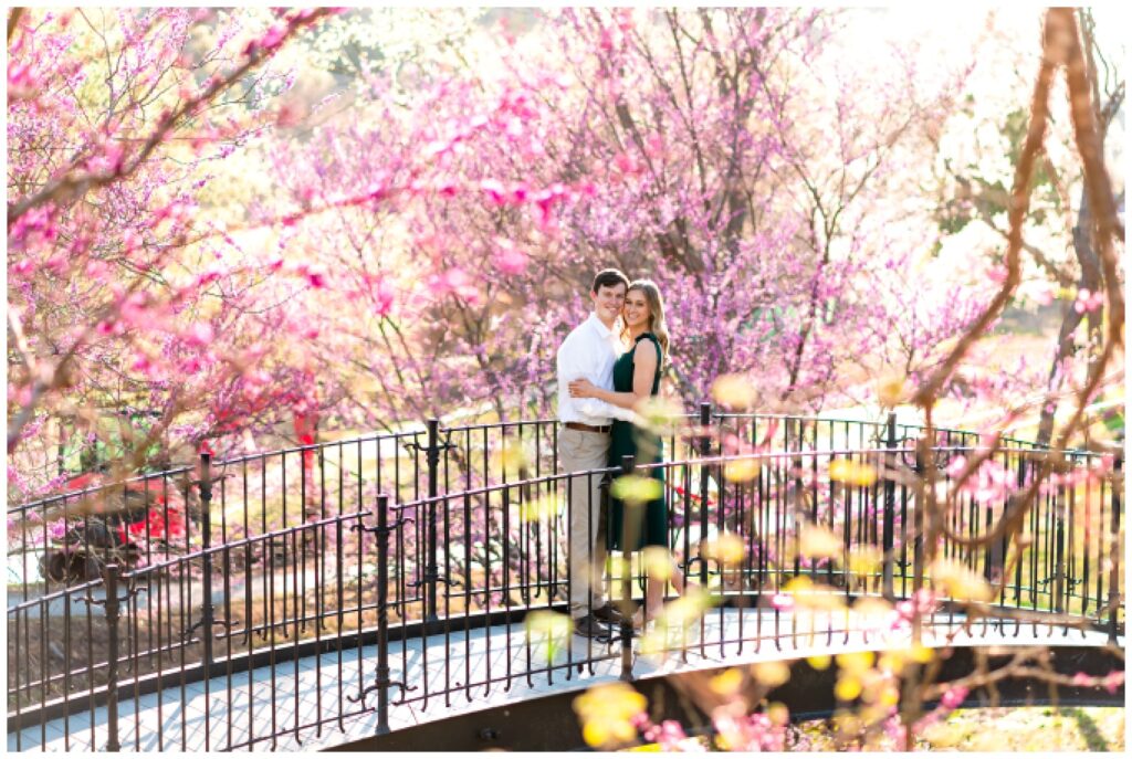 An engaged couple poses on a bridge at Big Cedar Lodge for their spring engagement session with Hannah Carr Photography, an Arkansas photographer located in Ash Flat, Arkansas