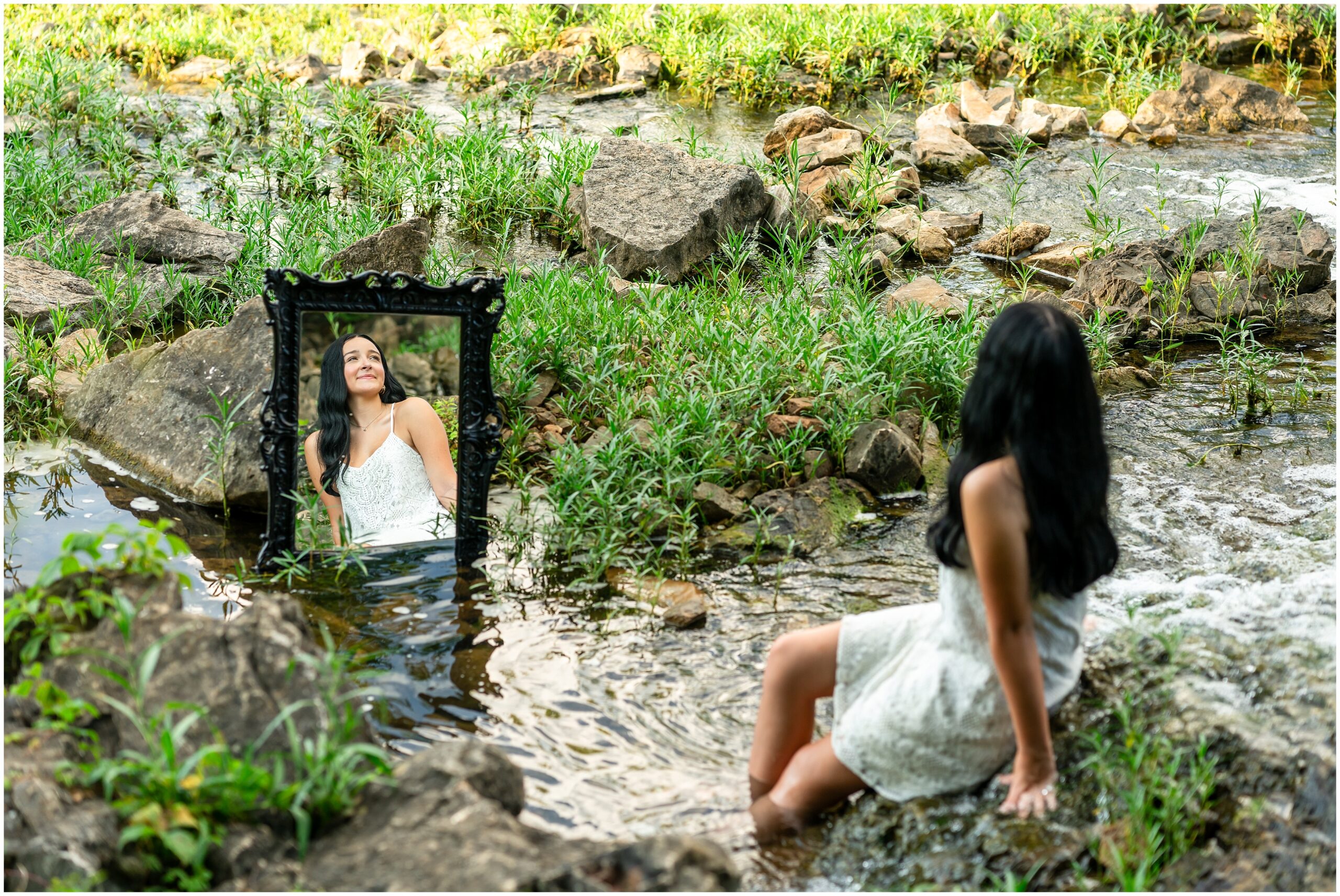 Highland High School senior, Dacy-Lynn, poses with a mirror in a stream in beautiful Cherokee Village, AR for her senior session with North Arkansas Senior Photographer, Hannah Carr Photography.