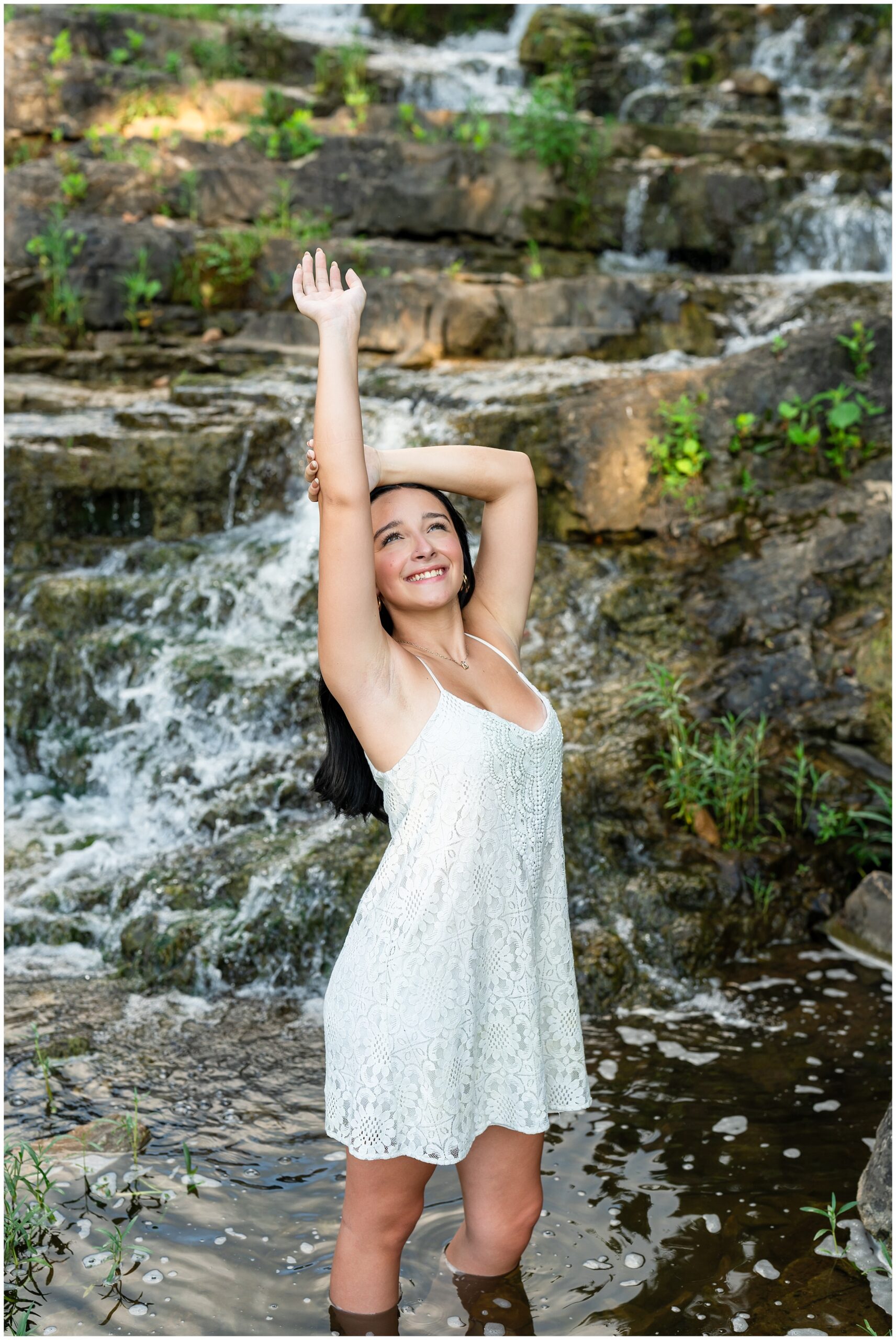 Highland High School senior, Dacy-Lynn, poses in a water fall in beautiful Cherokee Village, AR for her senior session with North Arkansas Senior Photographer, Hannah Carr Photography.