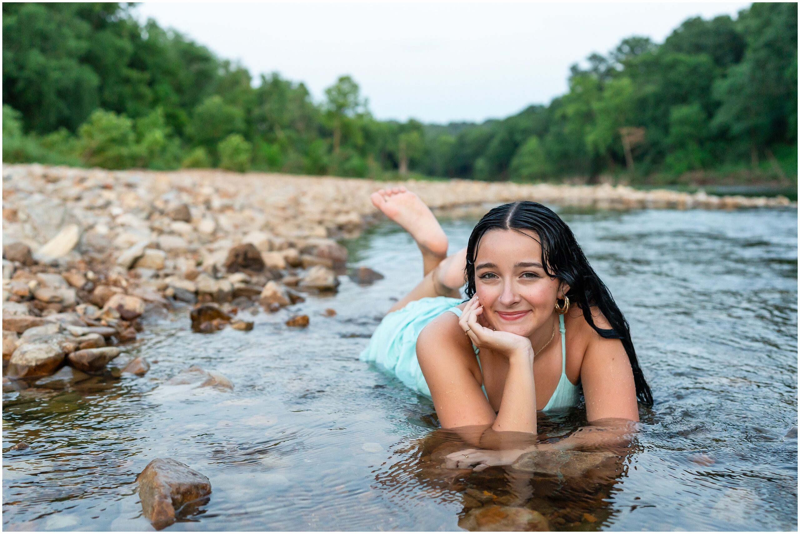 Highland High School senior, Dacy-Lynn, lays in a creek bed in beautiful Cherokee Village, AR for her senior session with North Arkansas Senior Photographer, Hannah Carr Photography.