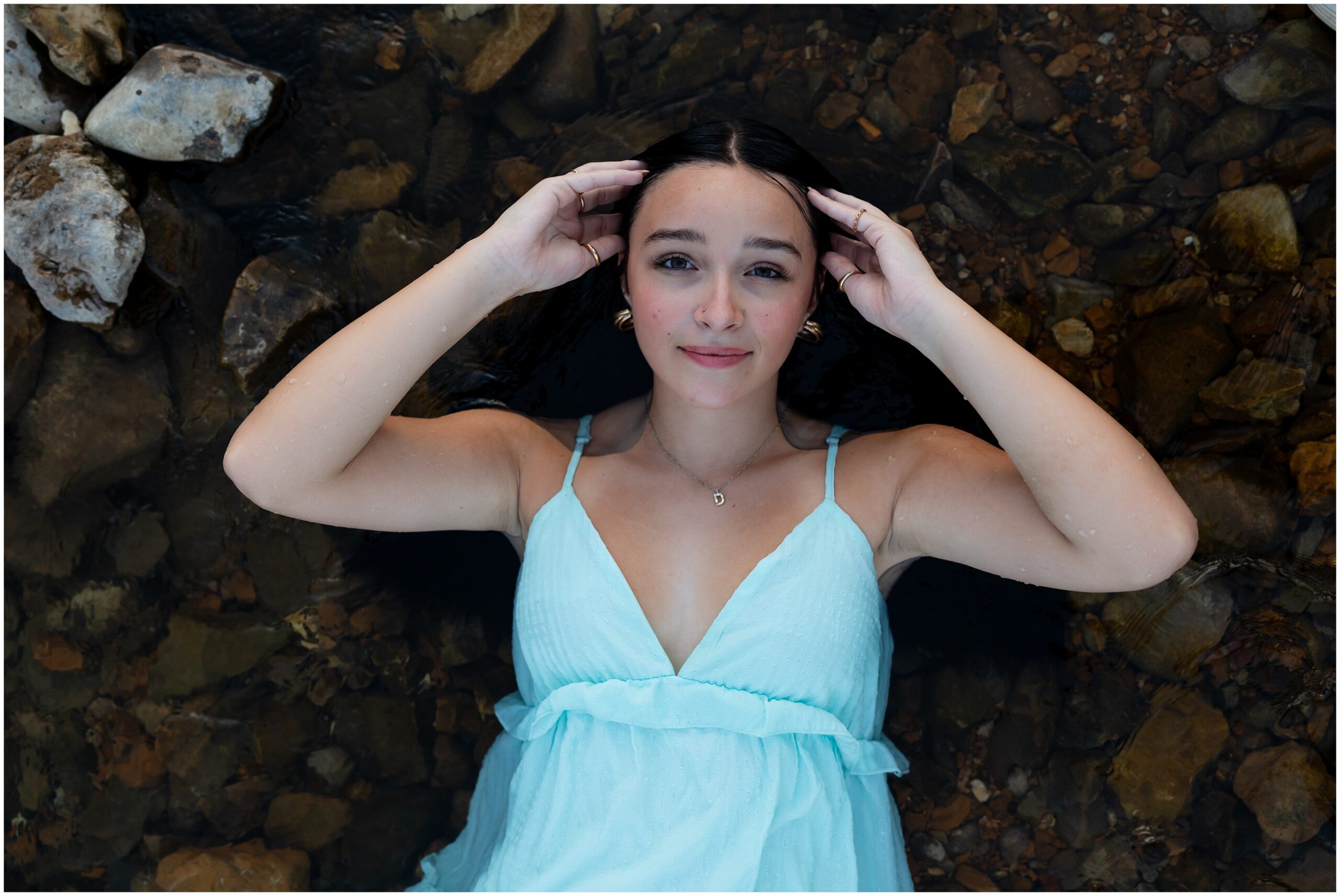 Highland High School senior, Dacy-Lynn, lays in a creek bed in beautiful Cherokee Village, AR for her senior session with North Arkansas Senior Photographer, Hannah Carr Photography.